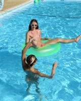 Asian chick Stefanie Moon is wearing pink stringkini getting sunburn by the pool