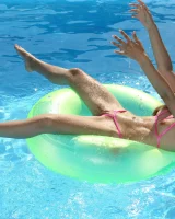 Asian chick Stefanie Moon is wearing pink stringkini getting sunburn by the pool