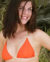 Young Bess in orange bikini and hidden hairy pussy in bikini on the beach