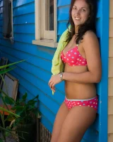 Tall hairy pussy Caitlin in pink bikini going nude at the house entrance