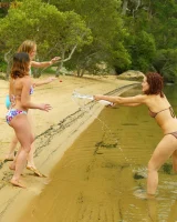Hairy pussies Lizzie, Morgana and Collette playing on the beach in bikinis and nude in the water