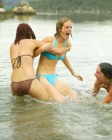 Hairy pussies Lizzie, Morgana and Collette playing on the beach in bikinis and nude in the water