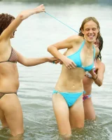 Hairy pussies Lizzie, Morgana and Collette playing on the beach in bikinis and nude in the water