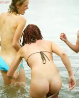 Hairy pussies Lizzie, Morgana and Collette playing on the beach in bikinis and nude in the water