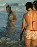 Four girls come to the beach, take off the cloth to stay in bikinis and have fun nude in the water