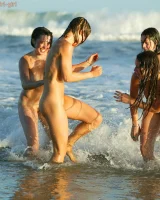 Four girls come to the beach, take off the cloth to stay in bikinis and have fun nude in the water