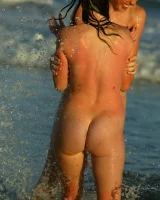 Four girls come to the beach, take off the cloth to stay in bikinis and have fun nude in the water