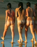 Four girls come to the beach, take off the cloth to stay in bikinis and have fun nude in the water