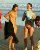 Four girls come to the beach, take off the cloth to stay in bikinis and have fun nude in the water