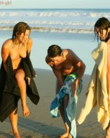 Four girls come to the beach, take off the cloth to stay in bikinis and have fun nude in the water