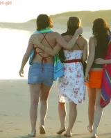 Four girls come to the beach, take off the cloth to stay in bikinis and have fun nude in the water