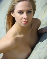 Blonde Bally is on the beach in red bikini and going nude on the white sands showing her erected nipples