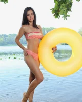 Young brunette Benita B shows her naked body and yummy pussy in an innertube