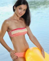 Young brunette Benita B shows her naked body and yummy pussy in an innertube