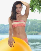 Young brunette Benita B shows her naked body and yummy pussy in an innertube