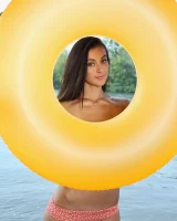Young brunette Benita B shows her naked body and yummy pussy in an innertube