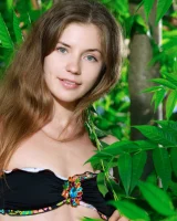 Sexy teen Celine in motley bikini in the forest with puffy nipples