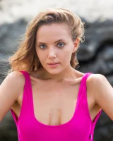Adorable teen Clover removes her 1 piece swimsuit to pose nude on rocks