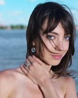 Thin girl Malvina takes off her bikini to pose nude on a beach towel