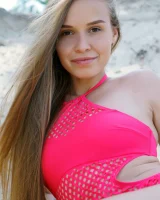 Need teen Pam E takes off a pink swimsuit to go nude on a sandbank