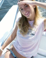 Nice girl Rena removes her bikini for nude poses while boating on a lake