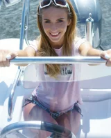 Nice girl Rena removes her bikini for nude poses while boating on a lake