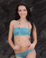 Brunette chick Sapphira takes off her bikini to pose nude on a sandy beach