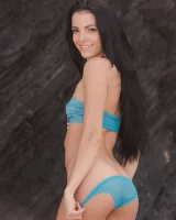 Brunette chick Sapphira takes off her bikini to pose nude on a sandy beach