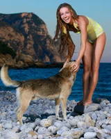 Long-haired beauty Sofiya removes a swimsuit for great nude seaside poses