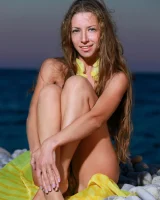 Long-haired beauty Sofiya removes a swimsuit for great nude seaside poses