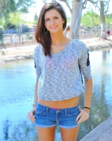 Slim sexy body Jody in tight jeans shorts and pink bikini is going fully nude outdoor at the canal