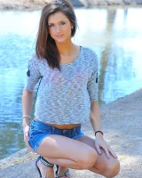 Slim sexy body Jody in tight jeans shorts and pink bikini is going fully nude outdoor at the canal