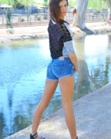 Slim sexy body Jody in tight jeans shorts and pink bikini is going fully nude outdoor at the canal