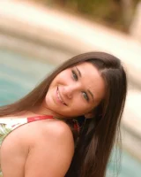 Amateur babe Natasha flashes her boobs and cute shaved pussy in the pool