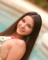 Amateur babe Natasha flashes her boobs and cute shaved pussy in the pool