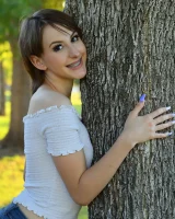 Long-legged amateur babe Tristan poses, strips and masturbates outdoors