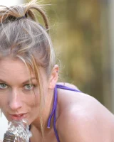 Sexy Victoria wets her hot ass and boobs with a water hose in the yard