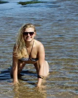 Hairy pussy Gretel in bikini going nude outside in the water to have her nipples puffy