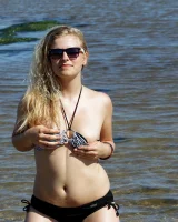 Hairy pussy Gretel in bikini going nude outside in the water to have her nipples puffy