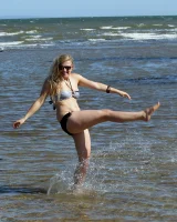 Hairy pussy Gretel in bikini going nude outside in the water to have her nipples puffy