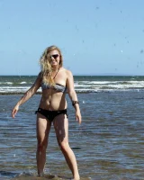 Hairy pussy Gretel in bikini going nude outside in the water to have her nipples puffy