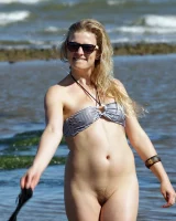 Hairy pussy Gretel in bikini going nude outside in the water to have her nipples puffy