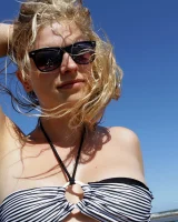 Hairy pussy Gretel in bikini going nude outside in the water to have her nipples puffy