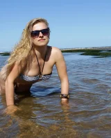 Hairy pussy Gretel in bikini going nude outside in the water to have her nipples puffy