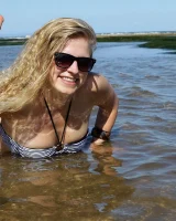 Hairy pussy Gretel in bikini going nude outside in the water to have her nipples puffy