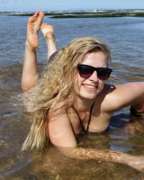 Hairy pussy Gretel in bikini going nude outside in the water to have her nipples puffy