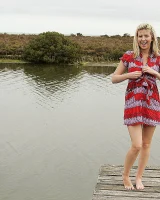 Blonde Melaina in green bikini flashing in the pier