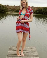 Blonde Melaina in green bikini flashing in the pier