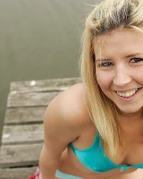 Blonde Melaina in green bikini flashing in the pier