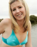 Blonde Melaina in green bikini flashing in the pier